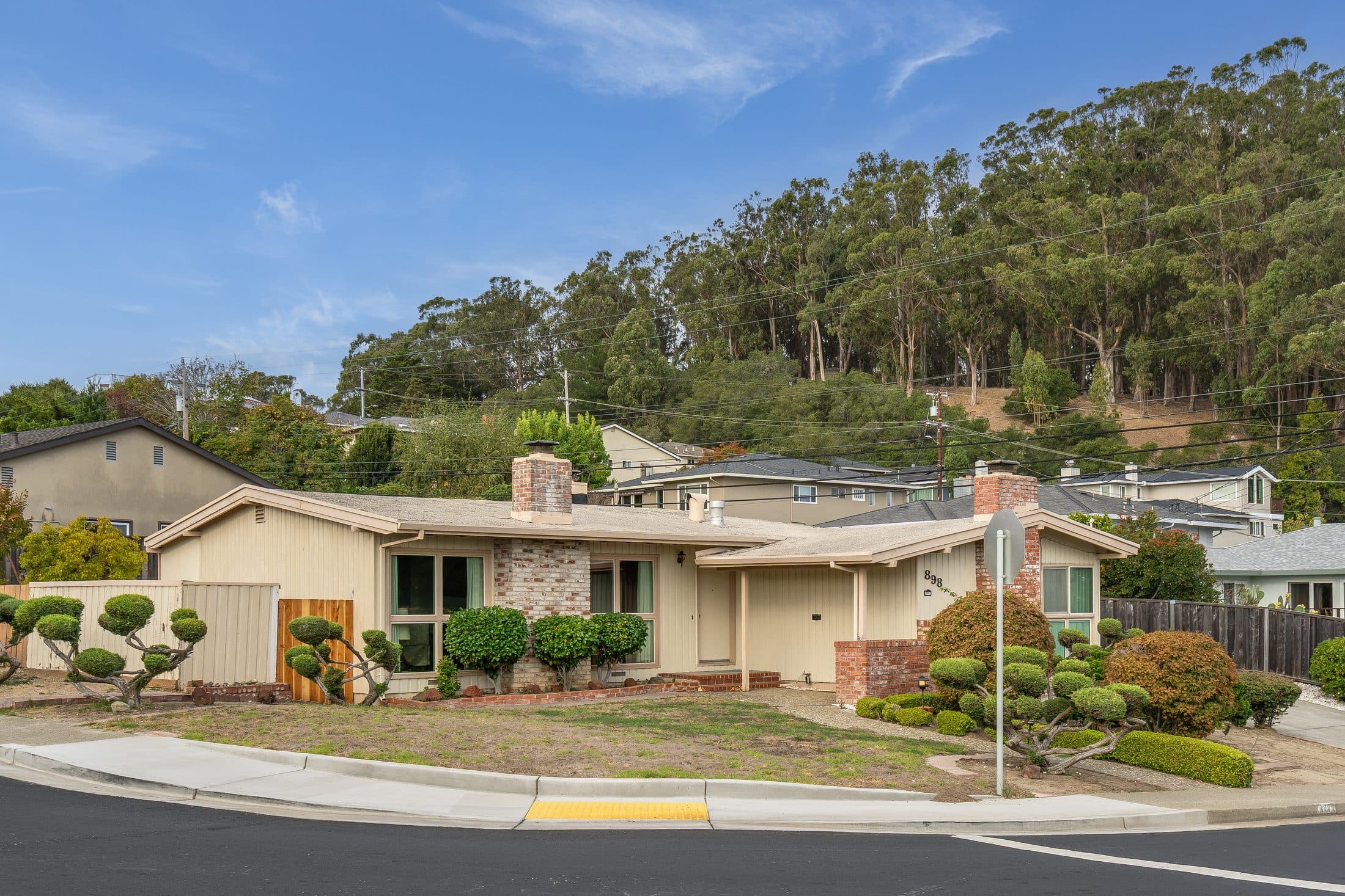 898 Lomita Avenue. The corner lot from across the street.